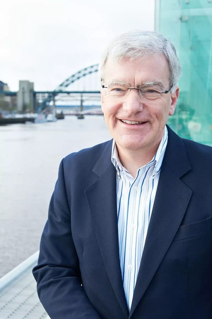 Martin hedley smiling outdoors in business attire, representing executive leadership.